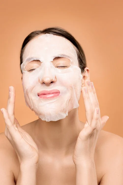 Smiling woman wearing a face mask with a delighted expression on her face